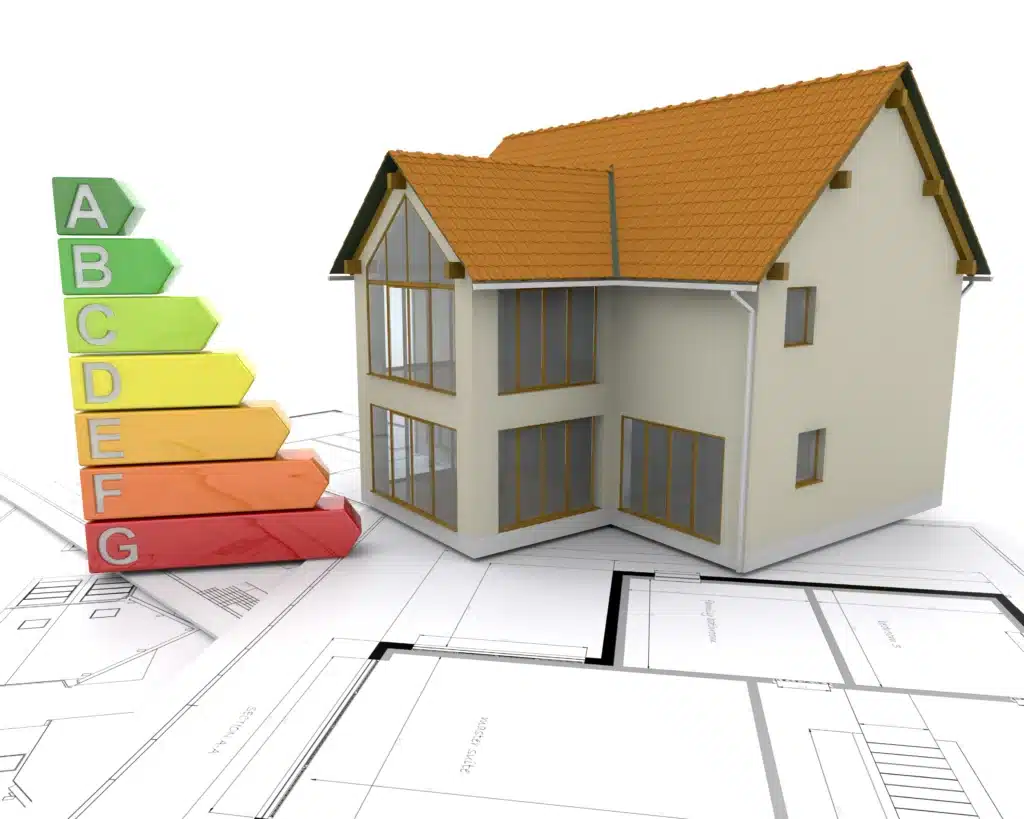 Eficiencia energética en edificios: medidas para ahorrar energía 2 Vivienda sobre planos arquitectónicos junto a una escala de eficiencia energética de la A a la G, con colores del verde al rojo para representar el rendimiento energético del edificio.