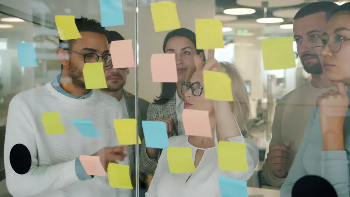 Identidad visual corporativa: elementos para construir una marca coherente 4 Equipo creativo organizando notas adhesivas durante una sesión de trabajo