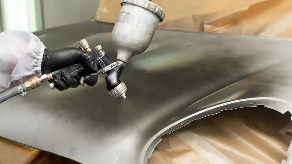 Chapa y pintura: 7 claves para un acabado perfecto 2 Pintor de chapa y pintura aplicando recubrimiento sobre una aleta de coche
