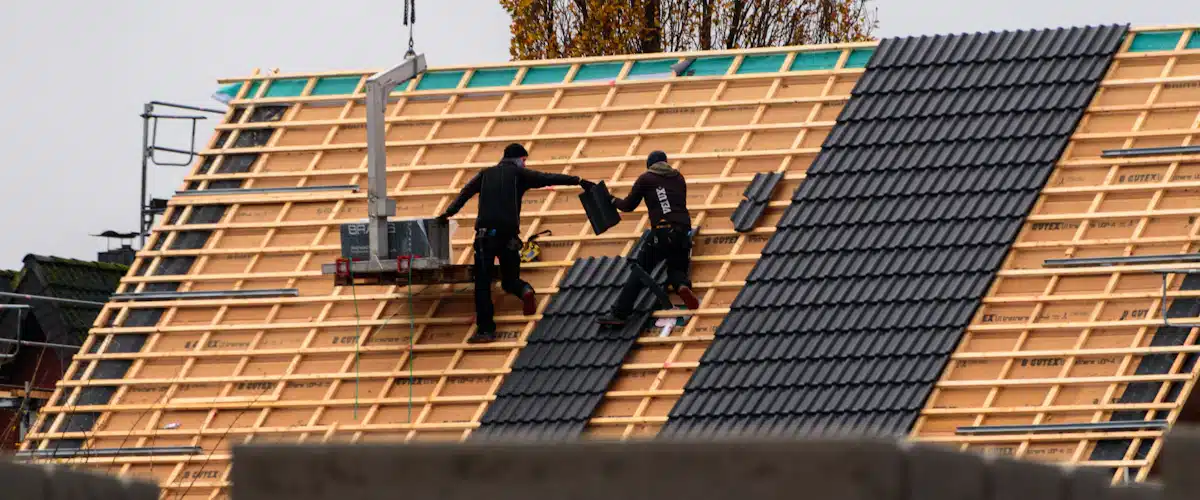 Jefe de obra: funciones, requisitos y control de acabados 8 Trabajadores colocan tejas durante la construcción de una cubierta
